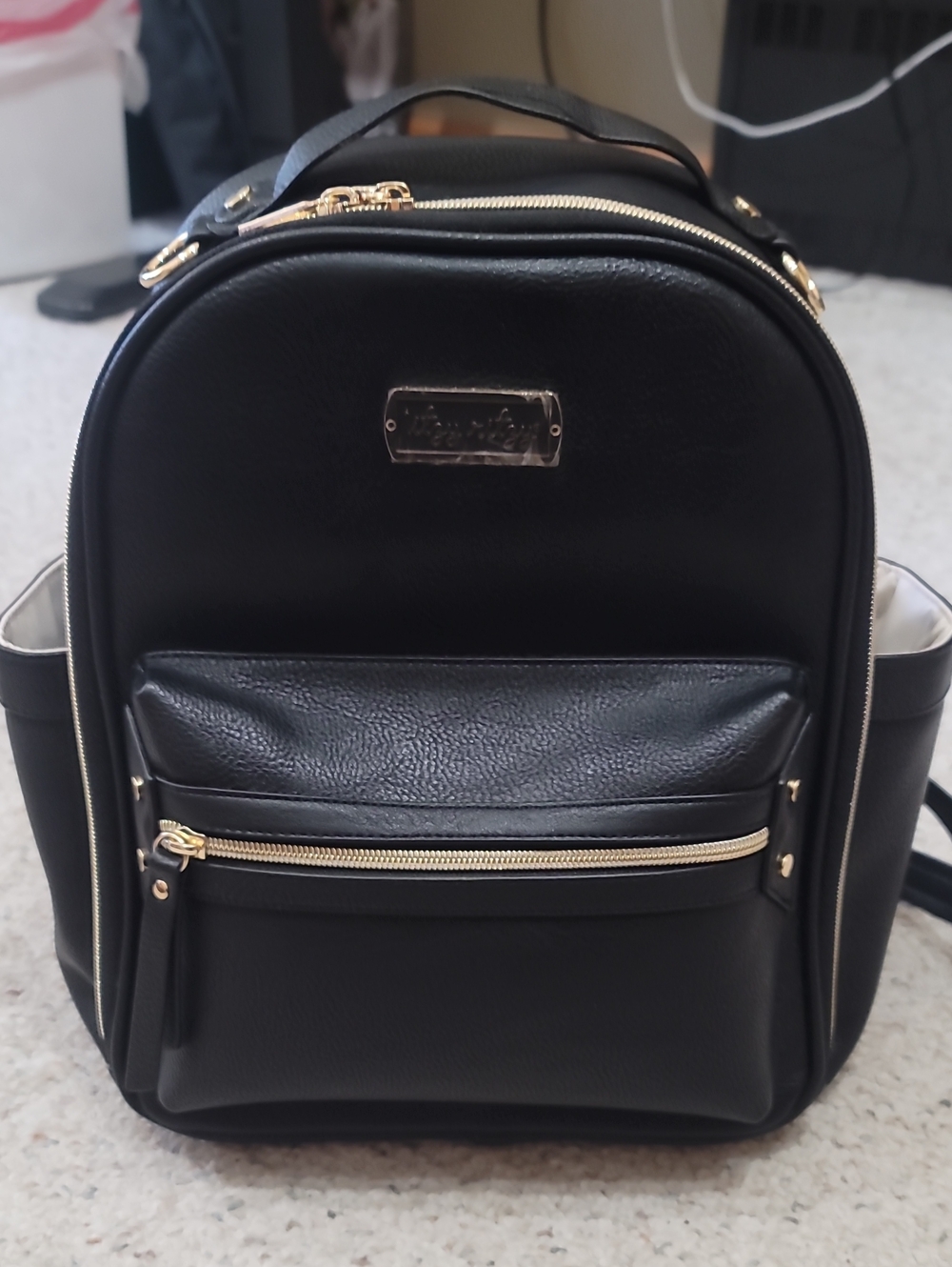 Itzy Ritzy Black Faux Leather Mini Backpack